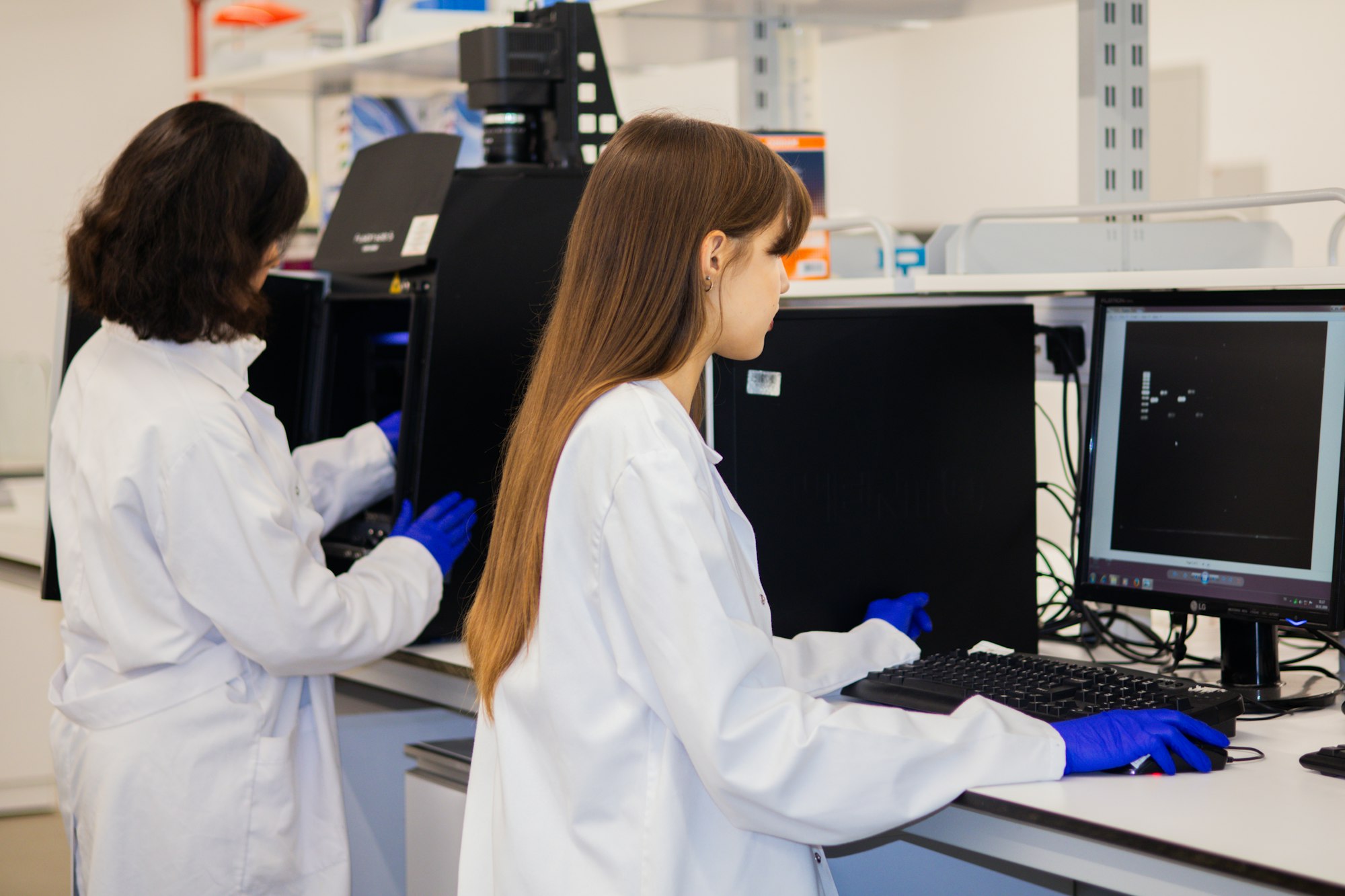 Two researchers reviewing results at a laboratory workstation